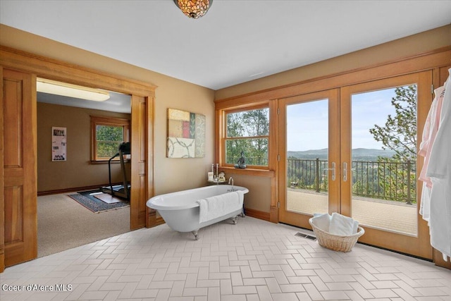 interior space with a mountain view and french doors