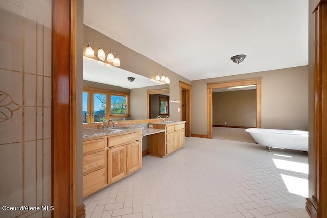 bathroom featuring a freestanding bath and vanity