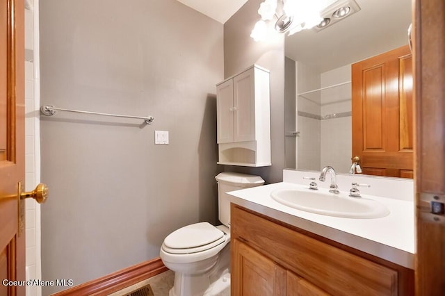 bathroom with walk in shower, vanity, and toilet