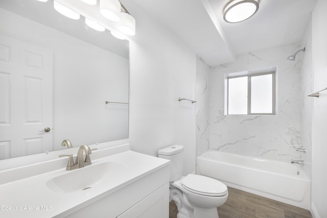 full bathroom featuring hardwood / wood-style flooring, toilet, vanity, and tiled shower / bath