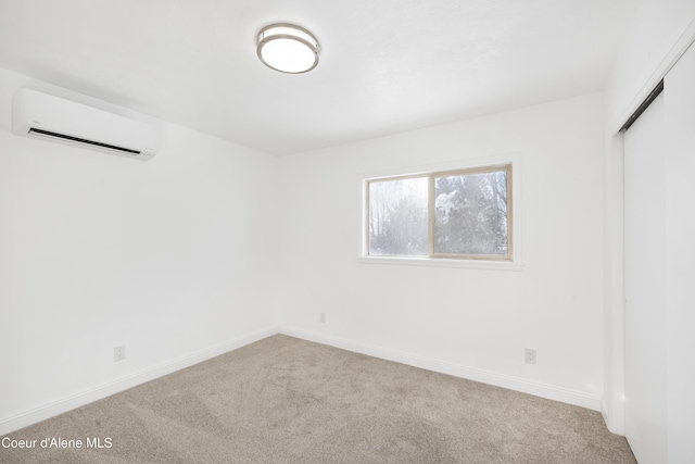 carpeted spare room with an AC wall unit