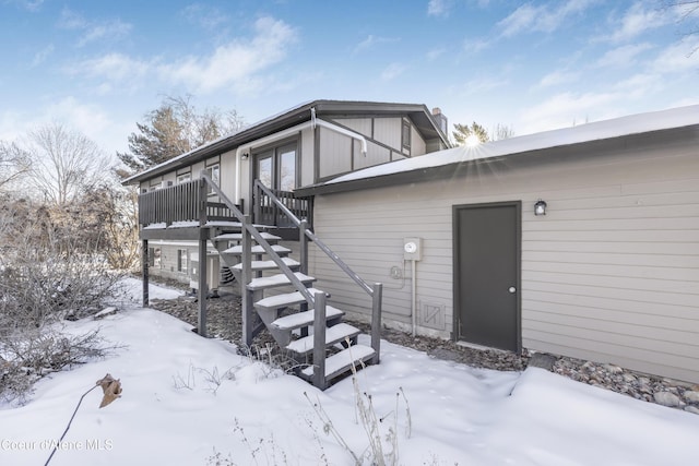 view of snow covered rear of property