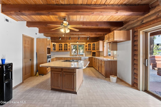 kitchen with rustic walls, wood ceiling, a center island, and beamed ceiling