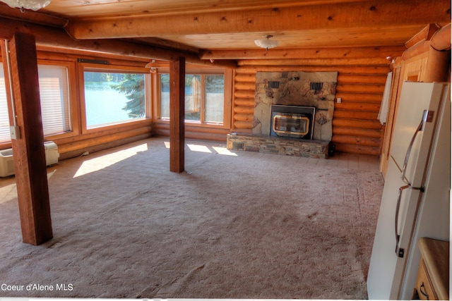 unfurnished living room featuring wood ceiling, light colored carpet, beam ceiling, and rustic walls