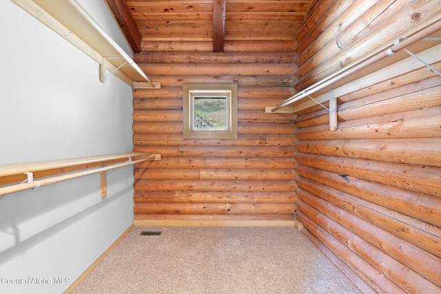 walk in closet with carpet floors