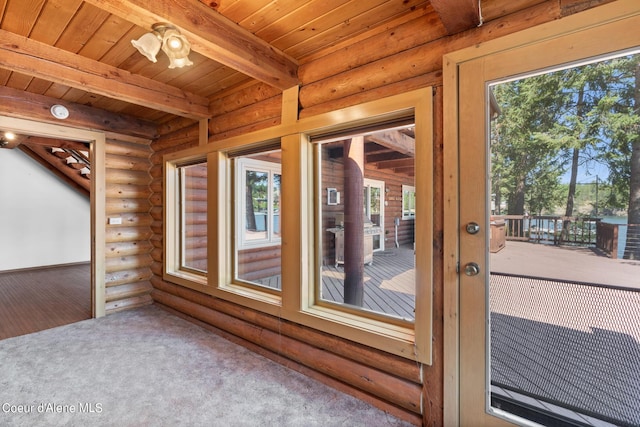 interior space featuring beam ceiling, wood ceiling, log walls, and carpet floors