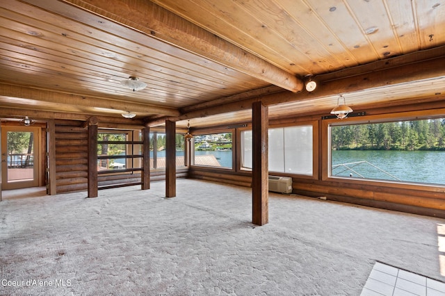 interior space featuring a water view, wooden ceiling, a wealth of natural light, and beamed ceiling