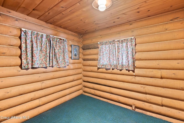 empty room with rustic walls and carpet