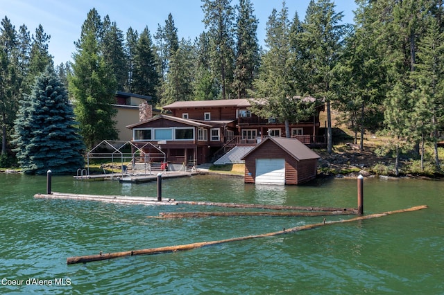 rear view of house featuring a water view