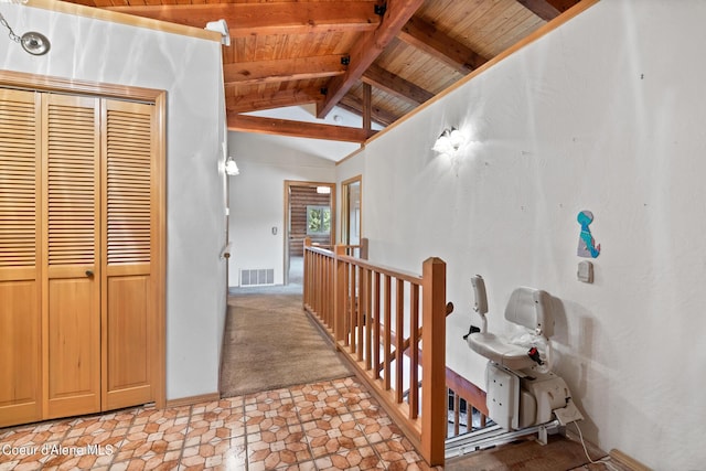 hallway featuring wooden ceiling, lofted ceiling with beams, and light colored carpet