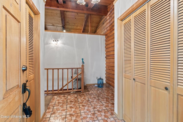 corridor with log walls, beam ceiling, and wood ceiling