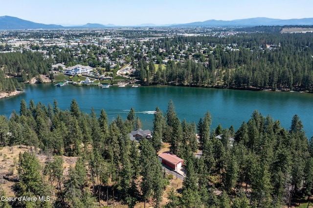 drone / aerial view featuring a water and mountain view