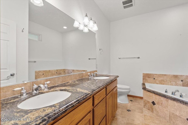 bathroom featuring tile patterned flooring, tiled tub, toilet, vanity, and an inviting chandelier