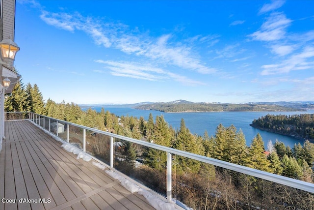 wooden deck featuring a water and mountain view