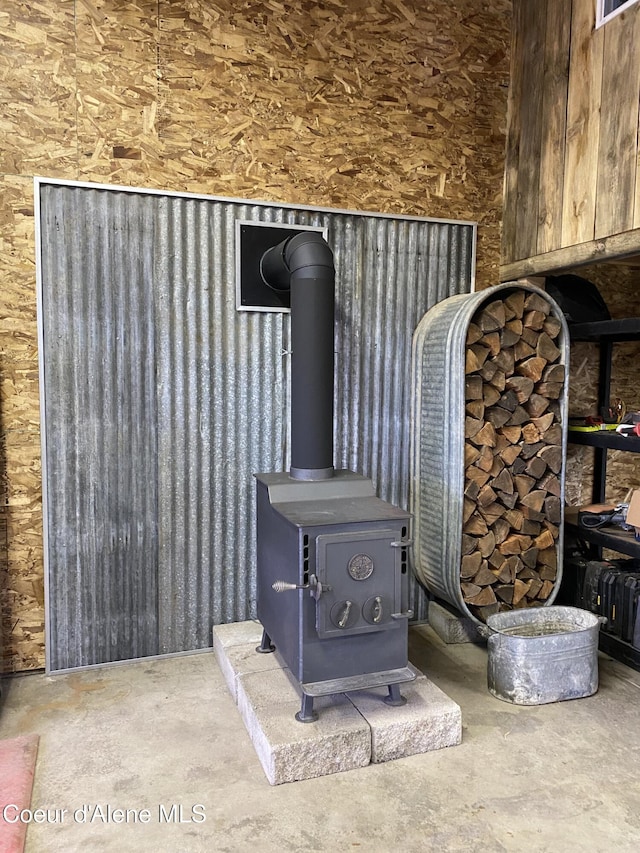 interior details featuring concrete floors and a wood stove