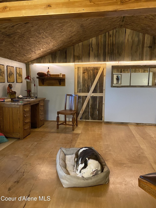 unfurnished room featuring lofted ceiling