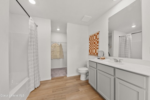 full bathroom with toilet, wood-type flooring, vanity, and shower / tub combo with curtain