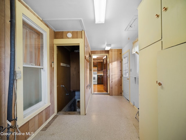 corridor featuring wooden walls