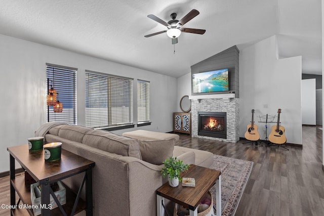 living room featuring hardwood / wood-style flooring, vaulted ceiling, a textured ceiling, and ceiling fan