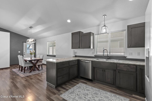 kitchen featuring dark hardwood / wood-style floors, decorative light fixtures, dishwasher, sink, and kitchen peninsula