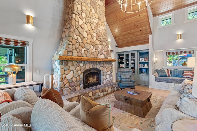 living room with wooden ceiling, hardwood / wood-style floors, a stone fireplace, and high vaulted ceiling