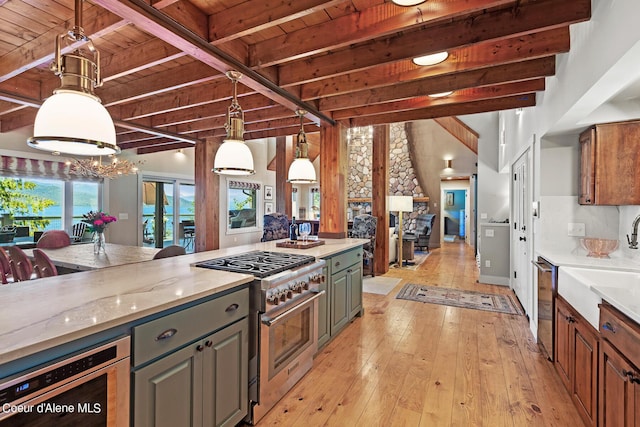 kitchen featuring appliances with stainless steel finishes, wood ceiling, beam ceiling, and light stone counters