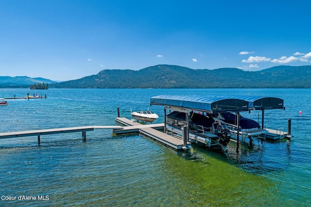 view of dock featuring a water and mountain view