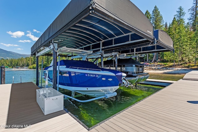 view of dock with a water and mountain view