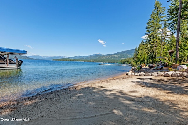 water view with a mountain view and a boat dock