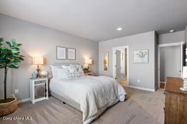 bedroom featuring light carpet and connected bathroom