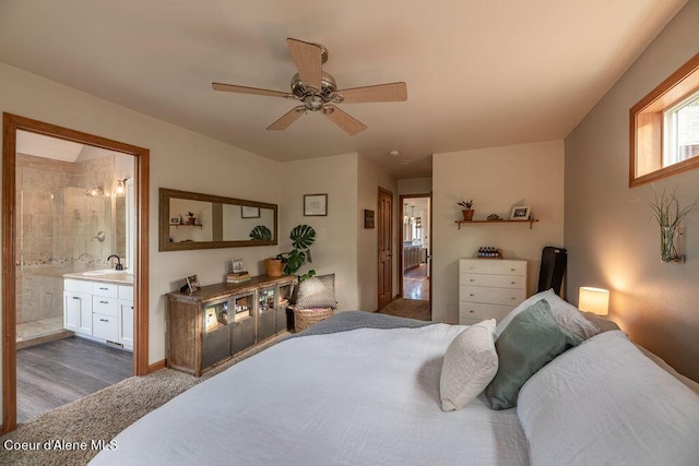 bedroom with ceiling fan, sink, and ensuite bath