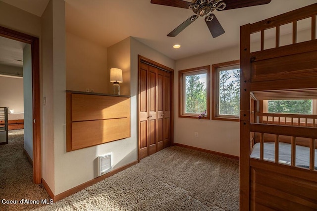 unfurnished bedroom featuring carpet floors, a closet, and ceiling fan