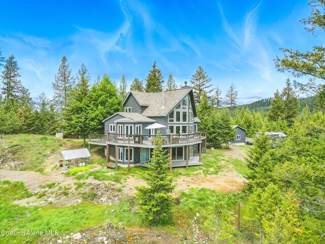 32 Angelina Way, Priest River, ID 83856 - back of house with a deck and a view of trees