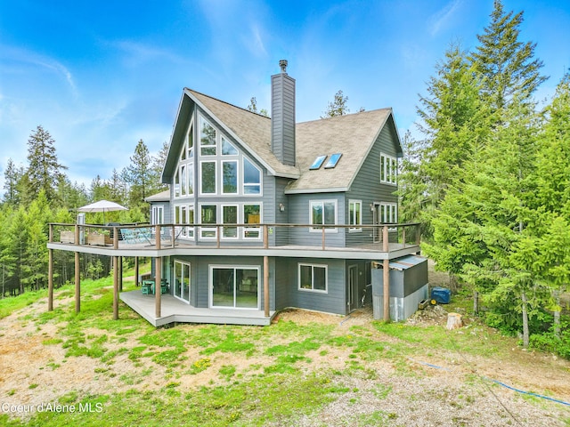 32 Angelina Way, Priest River, ID 83856 - back of house with a wooden deck and a chimney