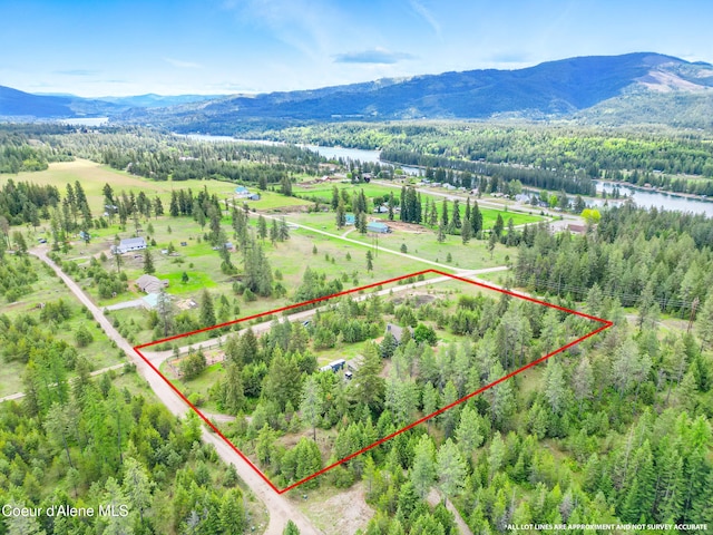 32 Angelina Way, Priest River, ID 83856 - overview of rural landscape with property parcel outlined, a heavily wooded area, and a water and mountain view