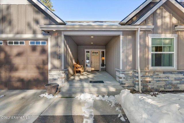 doorway to property with stone siding and board and batten siding