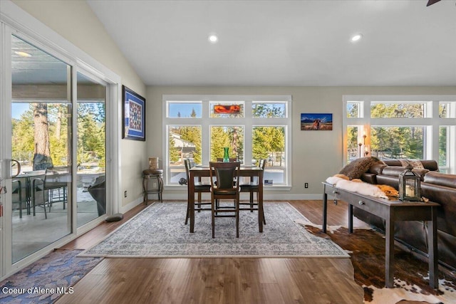 dining area featuring lofted ceiling, recessed lighting, wood finished floors, and baseboards