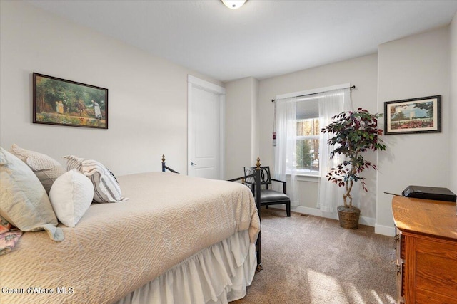 carpeted bedroom featuring baseboards