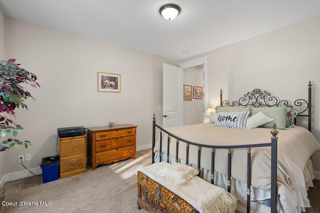 carpeted bedroom featuring baseboards