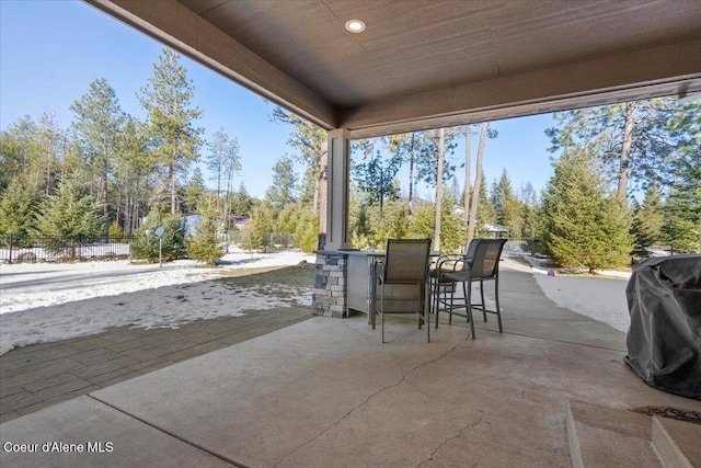 view of patio with outdoor dining area, fence, and grilling area