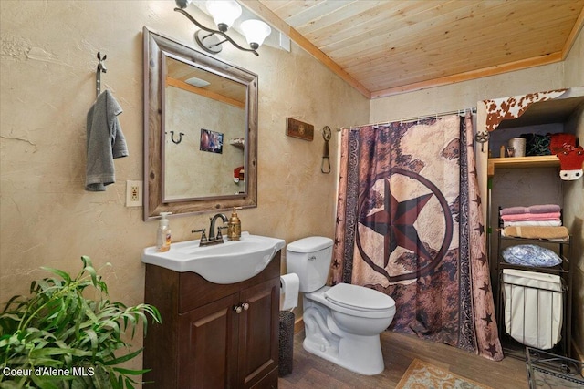 full bathroom with a textured wall, toilet, vanity, wood finished floors, and wooden ceiling