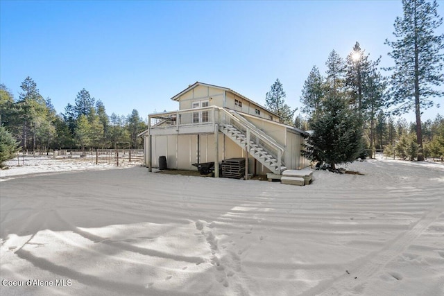 back of property featuring stairs and fence