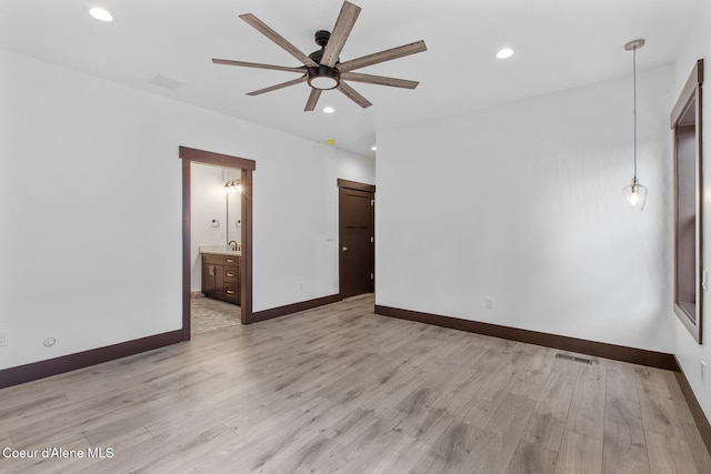 unfurnished bedroom with ceiling fan, light hardwood / wood-style flooring, and ensuite bath