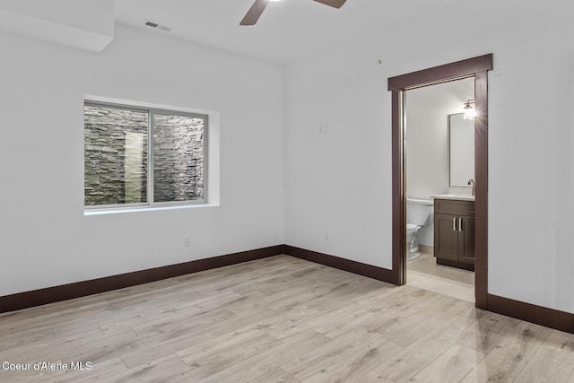 unfurnished room with ceiling fan, light hardwood / wood-style floors, and sink