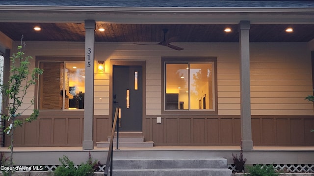 doorway to property with ceiling fan and covered porch