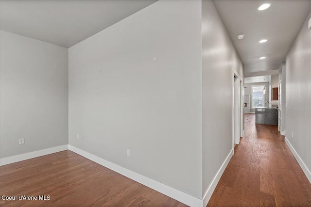 hallway with hardwood / wood-style flooring