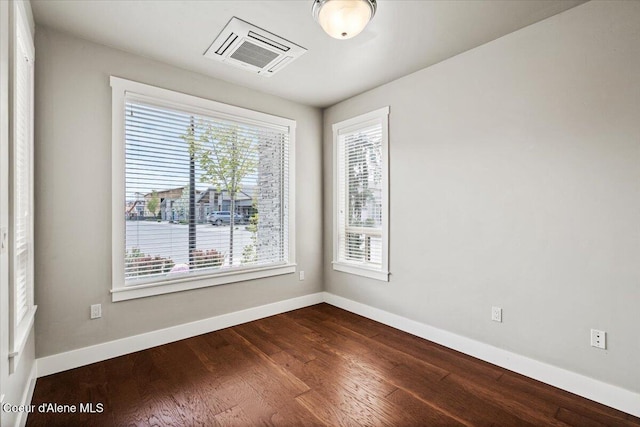 empty room with hardwood / wood-style flooring