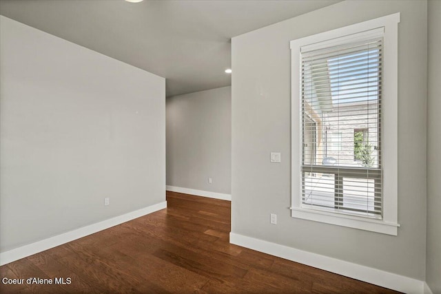 spare room featuring dark hardwood / wood-style flooring