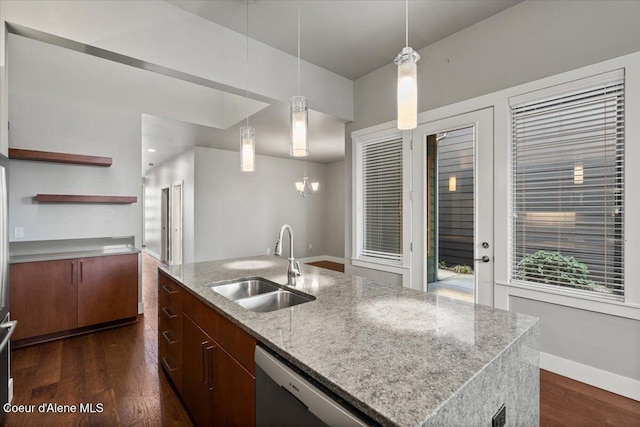 kitchen with an island with sink, dark hardwood / wood-style floors, sink, pendant lighting, and dishwashing machine