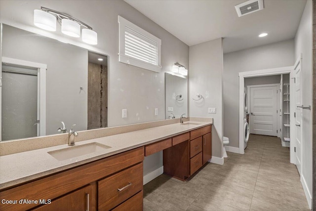 bathroom featuring toilet, a shower, and vanity